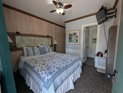 a bedroom with a bed and a ceiling fan at Squaw Valley Motel Room 2 in Squaw Valley