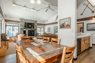 a dining room and living room with a table and chairs at Silverbear #41 - 2 Bedrm + Loft / 3 Bathrm 1/2 block to Canyon Lodge! Slps 8 in Mammoth Lakes