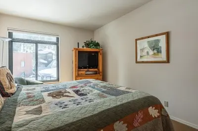 a bedroom with a bed with a quilt on it at Silverbear #41 - 2 Bedrm + Loft / 3 Bathrm 1/2 block to Canyon Lodge! Slps 8 in Mammoth Lakes