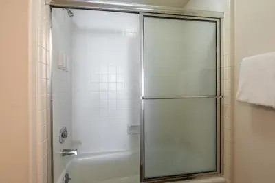 a shower with a glass door in a bathroom at Silverbear #41 - 2 Bedrm + Loft / 3 Bathrm 1/2 block to Canyon Lodge! Slps 8 in Mammoth Lakes