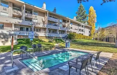 a swimming pool in front of a large building at LLC1236 - Lakeside Landing condo in South Lake Tahoe