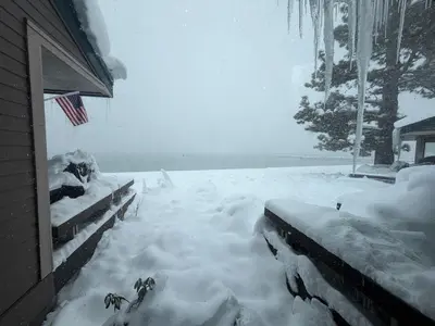a yard covered in snow next to a house at LLC1236 - Lakeside Landing condo in South Lake Tahoe