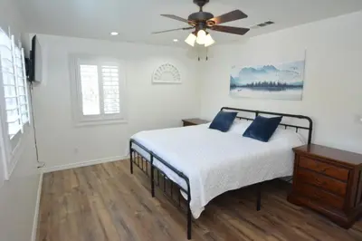 a bedroom with a bed and a ceiling fan at Bearadise At North Shore Winter Special in Bass Lake