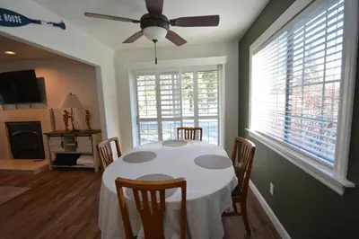 a dining room with a table with chairs and a ceiling fan at Bearadise At North Shore Winter Special in Bass Lake