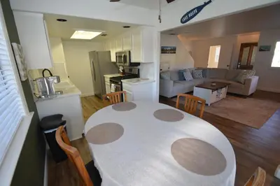 a kitchen and living room with a table and chairs at Bearadise At North Shore Winter Special in Bass Lake