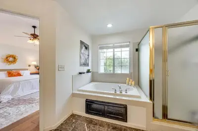 a white bathroom with a tub and a bed at Rudraksha-Luxurious 5 BR House, Prime Location, Shopping, Dining, Medical, Education, Tourist Attractions in Fresno