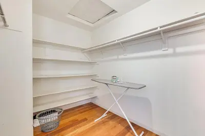 a room with white shelves and a table in it at Rudraksha-Luxurious 5 BR House, Prime Location, Shopping, Dining, Medical, Education, Tourist Attractions in Fresno