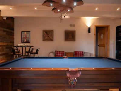 a pool table in a living room with a ceiling at Updated Cabin near Beach&Ski HotTub Sauna Pets EV in Tahoe City