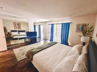 a bedroom with a large bed and a living room at 3BR Condo Near Lake & Skiing in Incline Village