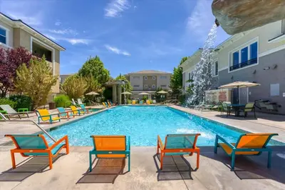 a swimming pool with colorful chairs and tables at New Elegant 1BR Retreat Heated Pool Gym & Sauna in Reno