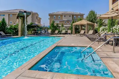 a swimming pool with chairs and umbrellas at a hotel at New Elegant 1BR Retreat Heated Pool Gym & Sauna in Reno