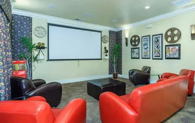 a living room with red furniture and a white screen at New Elegant 1BR Retreat Heated Pool Gym & Sauna in Reno