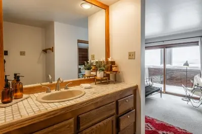 a bathroom with a sink and a mirror at Cedar and Snow in Mammoth Lakes