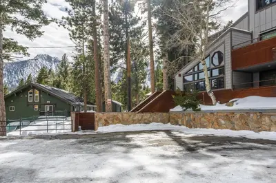a house in the woods with snow on the ground at Cedar and Snow in Mammoth Lakes