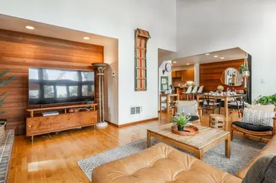 a living room with a couch and a tv at Cedar and Snow in Mammoth Lakes