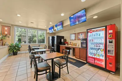 a restaurant with tables and chairs and a soda machine at New Stylish 1BR Apt with Heated Pool Gym & Yoga Studio in Reno