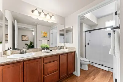 a bathroom with two sinks and a shower at New Stylish 1BR Apt with Heated Pool Gym & Yoga Studio in Reno