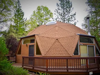 a house with a large roof on a deck at Unique and Secluded Dome Getaway near Sacramento, California in Pioneer