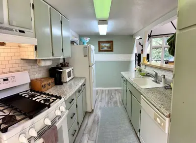 a kitchen with a white stove top oven next to a sink at Unique and Secluded Dome Getaway near Sacramento, California in Pioneer
