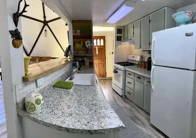 a kitchen with a white refrigerator and a counter top at Unique and Secluded Dome Getaway near Sacramento, California in Pioneer