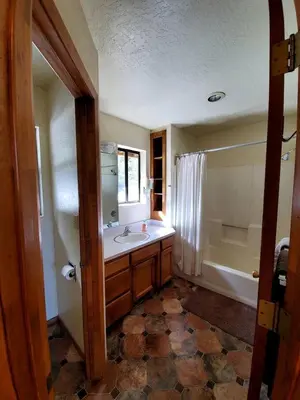 a bathroom with a sink and a bath tub at Blue Jay's Nest Sequoia Cabin in Ponderosa, CA in Ponderosa