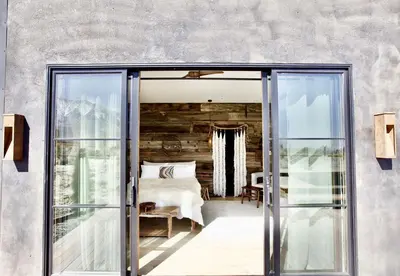 a bedroom with sliding glass doors and a bed at Stunning Design Rental Incredible for a Luxury Escape in Lone Pine, California in Lone Pine