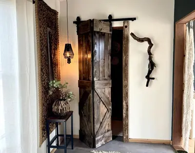 an old wooden door in a room with a lamp at Stunning Design Rental Incredible for a Luxury Escape in Lone Pine, California in Lone Pine