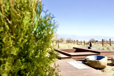 a group of picnic tables with a view of the ocean at Stunning Design Rental Incredible for a Luxury Escape in Lone Pine, California in Lone Pine
