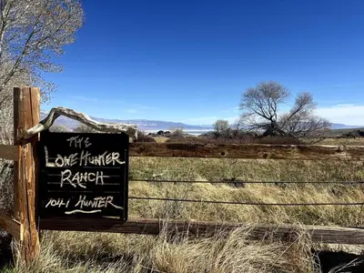 a sign on a fence in a field at Stunning Design Rental Incredible for a Luxury Escape in Lone Pine, California in Lone Pine