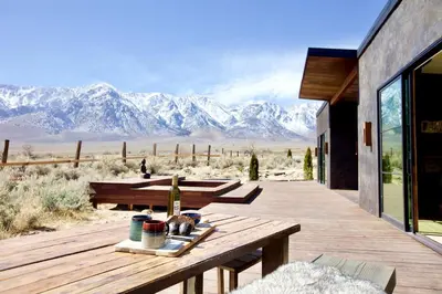 a wooden deck with a view of the mountains at Stunning Design Rental Incredible for a Luxury Escape in Lone Pine, California in Lone Pine