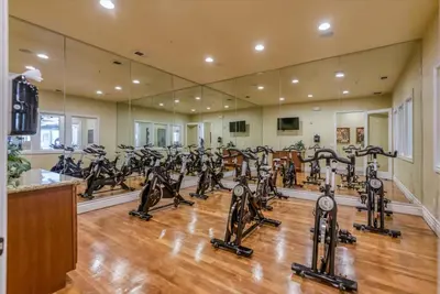 a gym with a lot of treadmills and ellipticals at New Trendy 1BR Apartment with Heated Pool Gym & Minigolf in Reno