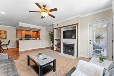 a living room with a ceiling fan and a fireplace at New Trendy 1BR Apartment with Heated Pool Gym & Minigolf in Reno