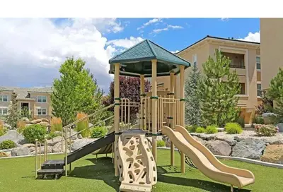 a playground with a slide in a park at New Cozy 1BR Apt with Gym Sauna & Heated Pool Access in Reno