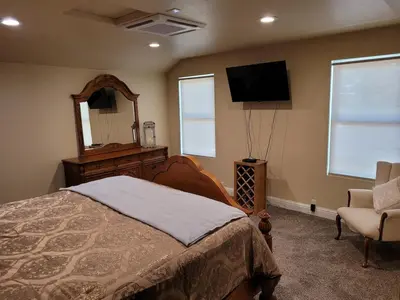 a bedroom with a bed and a mirror and a tv at Newly remodeled mountain home! in Floriston
