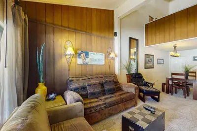 a living room with a couch and a table at Summit 295 in Mammoth Lakes