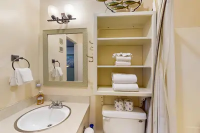 a bathroom with a sink and a toilet and a mirror at Summit 295 in Mammoth Lakes