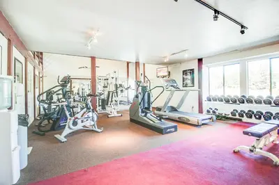 a gym with several treadmills and exercise machines at Summit 295 in Mammoth Lakes