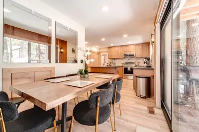 a kitchen and dining room with a wooden table and chairs at Ski, Hike and Fish Cabin with Deck in Soda Springs! in Soda Springs