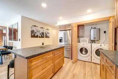 a kitchen with a washer and dryer in it at Ski, Hike and Fish Cabin with Deck in Soda Springs! in Soda Springs