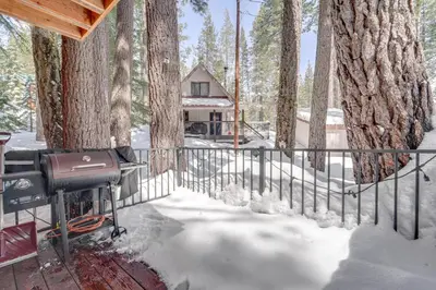 a house in the woods with snow on the ground at Ski, Hike and Fish Cabin with Deck in Soda Springs! in Soda Springs
