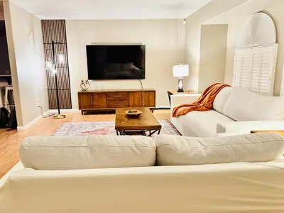 a living room with a couch and a tv at Home at Yosemite Oakhurst in Oakhurst