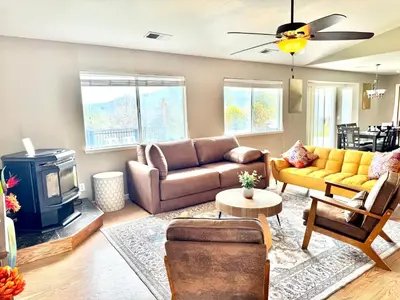 a living room with a couch and a stove at Home at Yosemite Oakhurst in Oakhurst