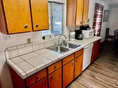 a kitchen with a sink and a counter top at Home in Yosemite-Brookside Cottage-Sleeps 10 in Yosemite West