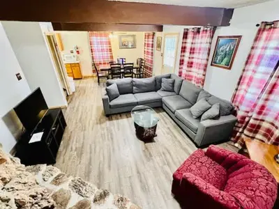 a living room with a couch and a table at Home in Yosemite-Brookside Cottage-Sleeps 10 in Yosemite West