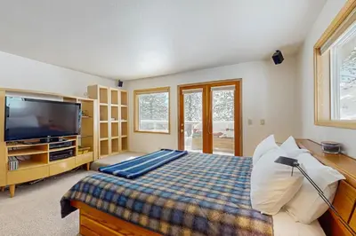 a bedroom with a bed and a flat screen tv at Mountain View Getaway in Stateline