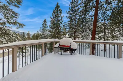 a bench covered in snow on a deck at Mountain View Getaway in Stateline