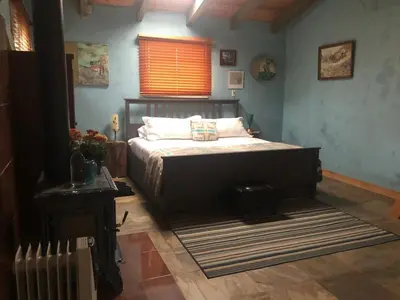 a bedroom with a bed and a radiator and a window at Delilah Ridge Winery Mid Mod Guesthouse in Squaw Valley