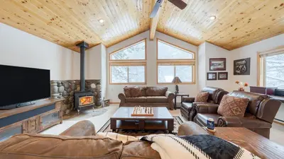 a living room with leather furniture and a flat screen tv at Oslo Haus by AvantStay Cabin Retreat Near Northstar Downtown Truckee in Truckee