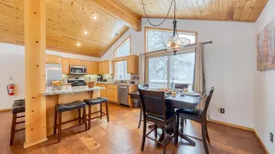 a kitchen with a table and chairs in a room at Oslo Haus by AvantStay Cabin Retreat Near Northstar Downtown Truckee in Truckee
