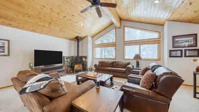 a living room with leather furniture and a flat screen tv at Oslo Haus by AvantStay Cabin Retreat Near Northstar Downtown Truckee in Truckee